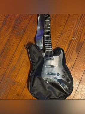 Parcel: Black Electric Guitar with Silver Pickguard